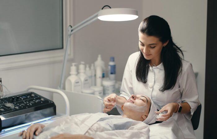 Dermatologist performing a facial skin treatment at a skin clinic