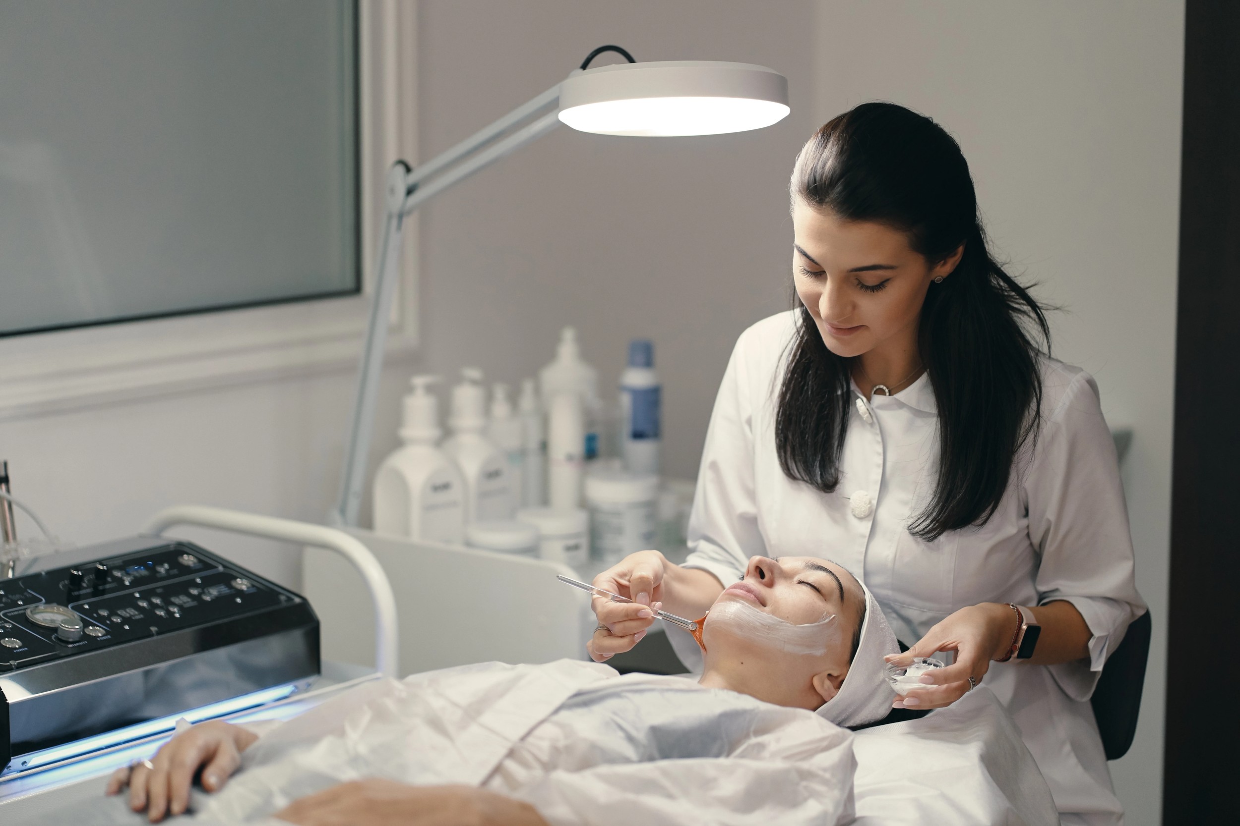 Dermatologist performing a facial skin treatment at a skin clinic